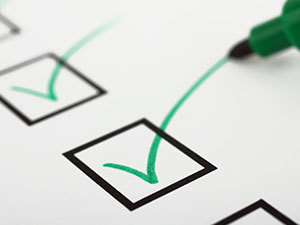 Close up of a checklist with green checkmarks