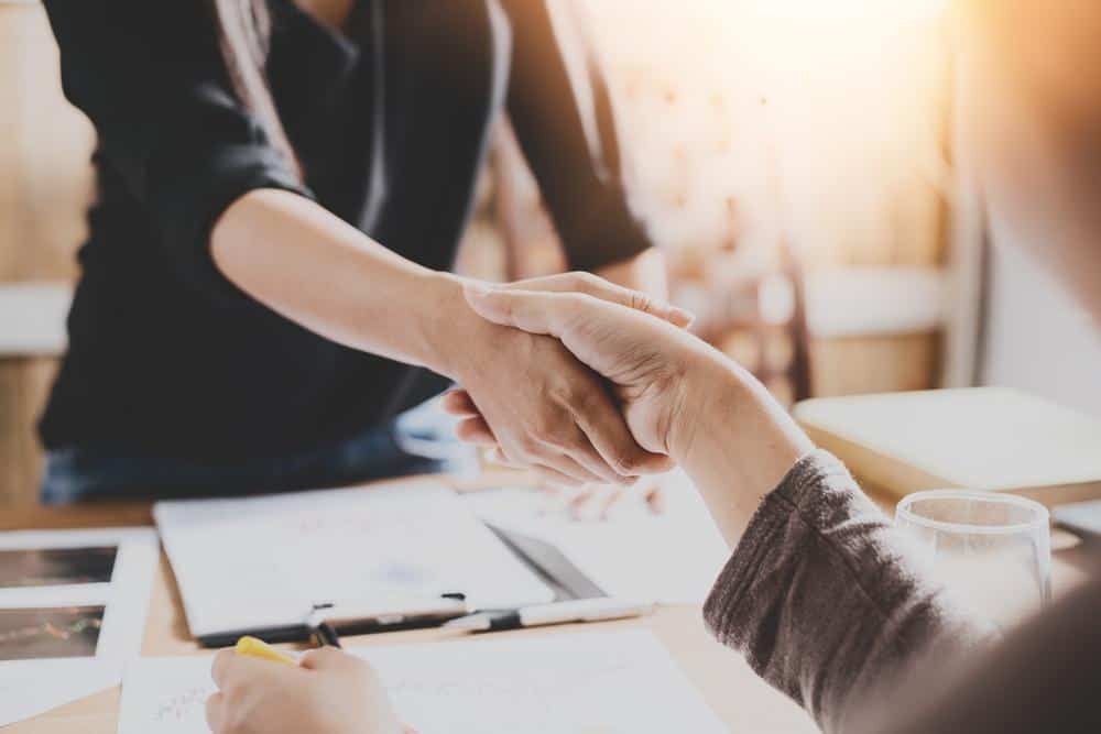 Close up of a handshake between to people.